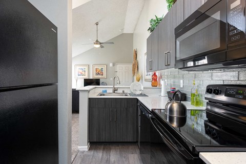a modern kitchen with stainless steel appliances and black appliances