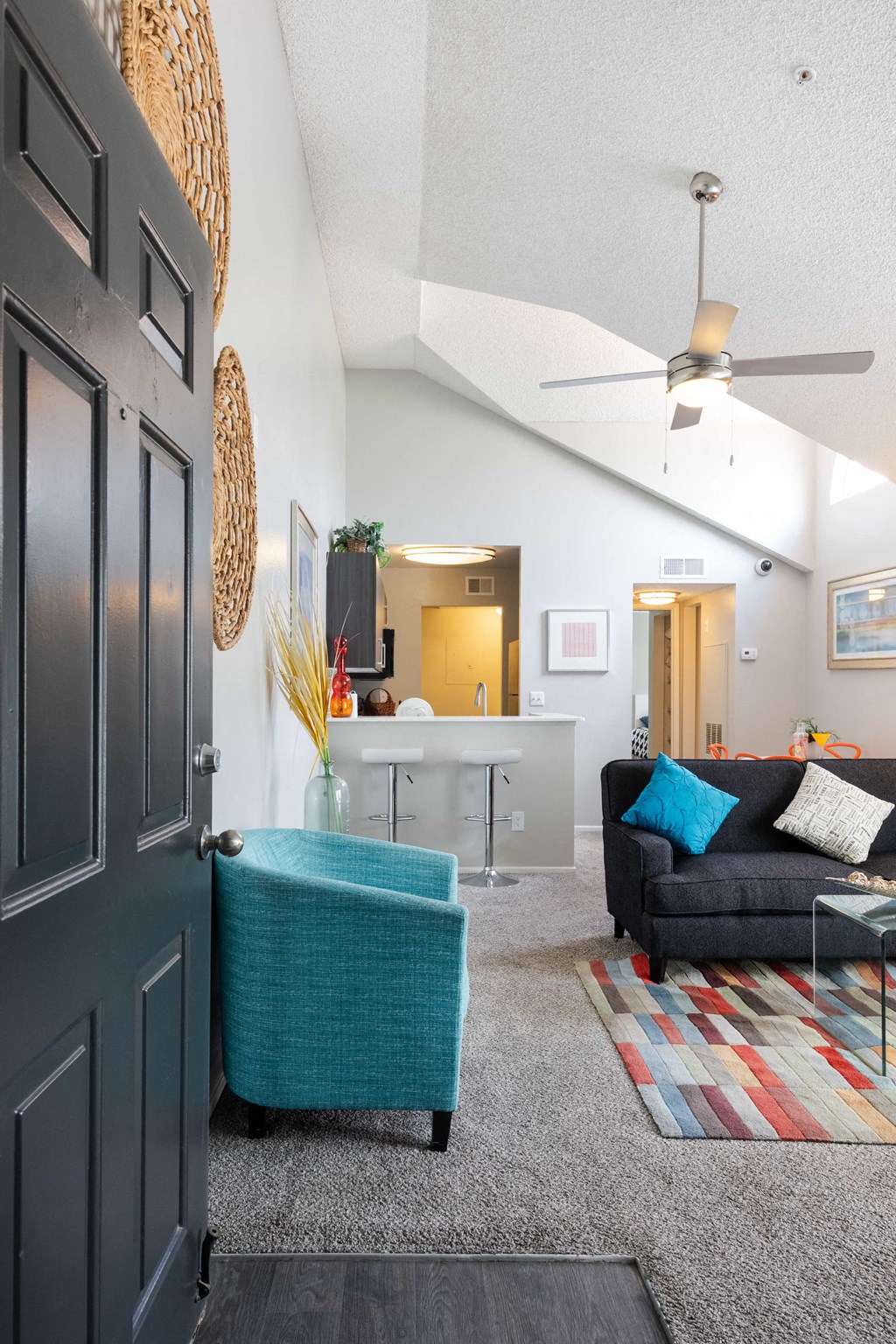 a living room with a couch and a chair and a closet