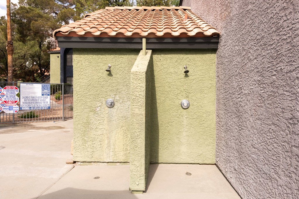 a small yellow building with a tiled roof and two doors
