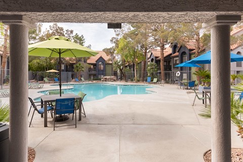 our apartments have a swimming pool with tables and umbrellas