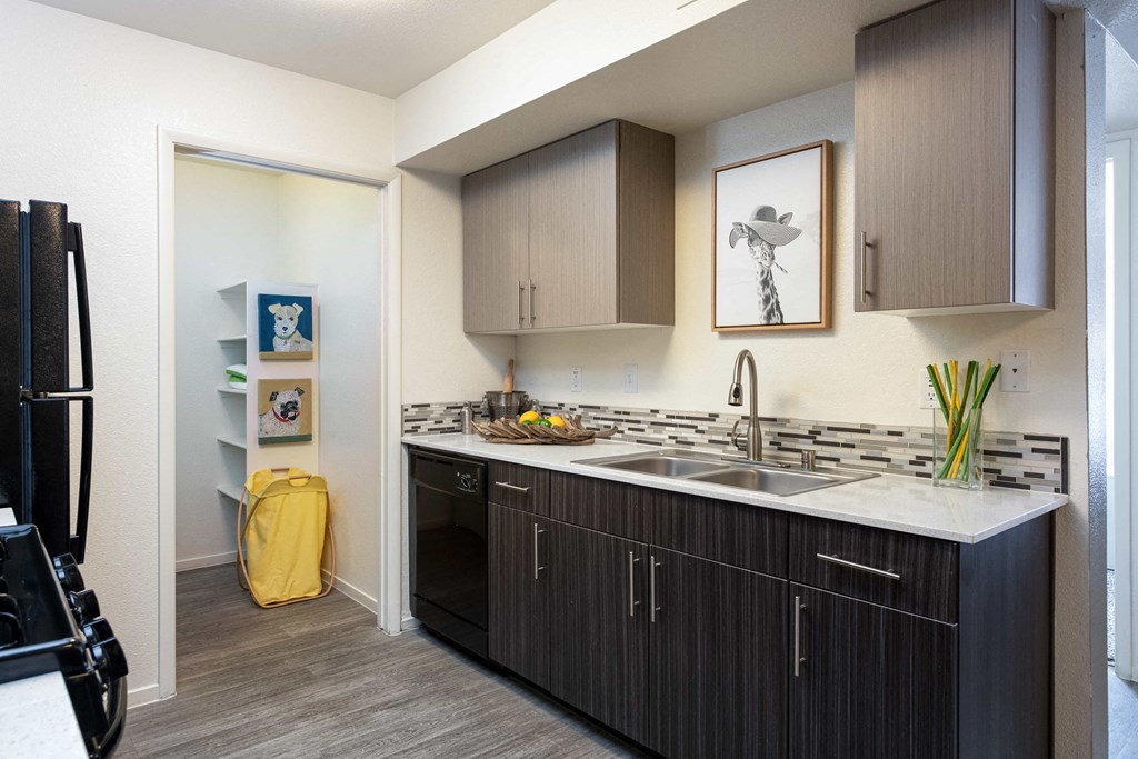 a kitchen with wooden cabinets and a white counter top
