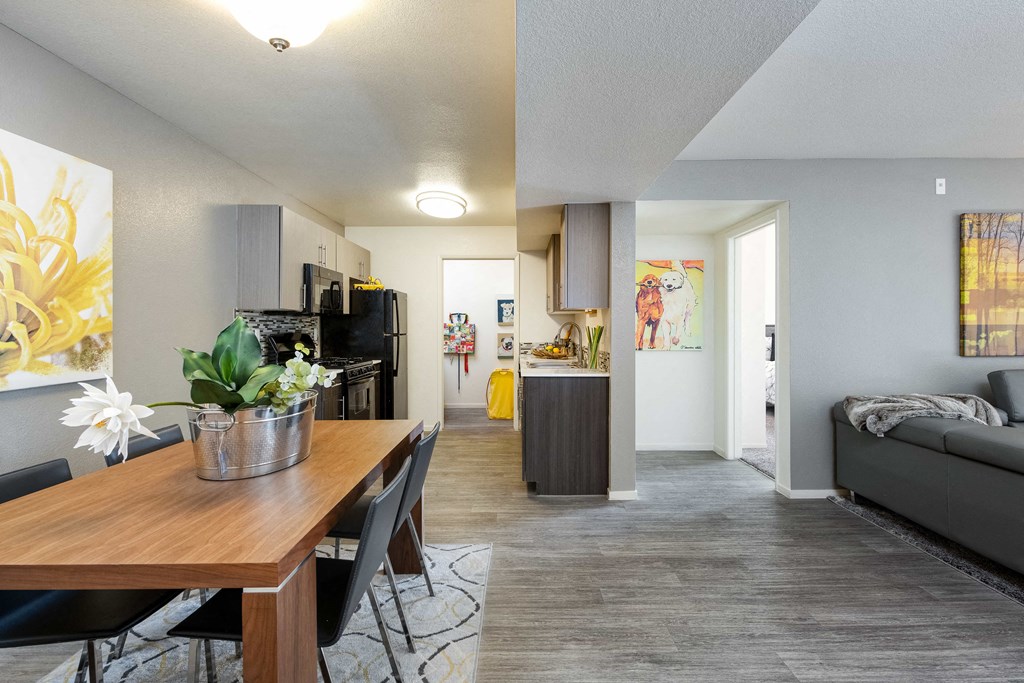 the living room and dining room of an apartment