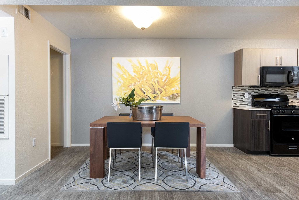 a dining room with a table and chairs and a kitchen