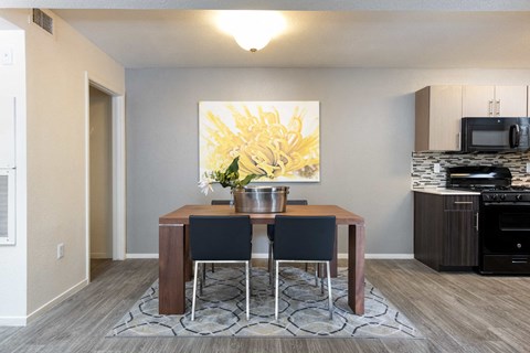 a dining room with a table and chairs and a kitchen