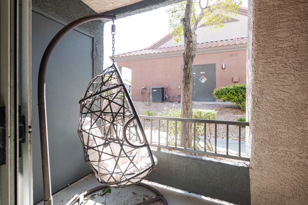 a hanging chair in front of a window