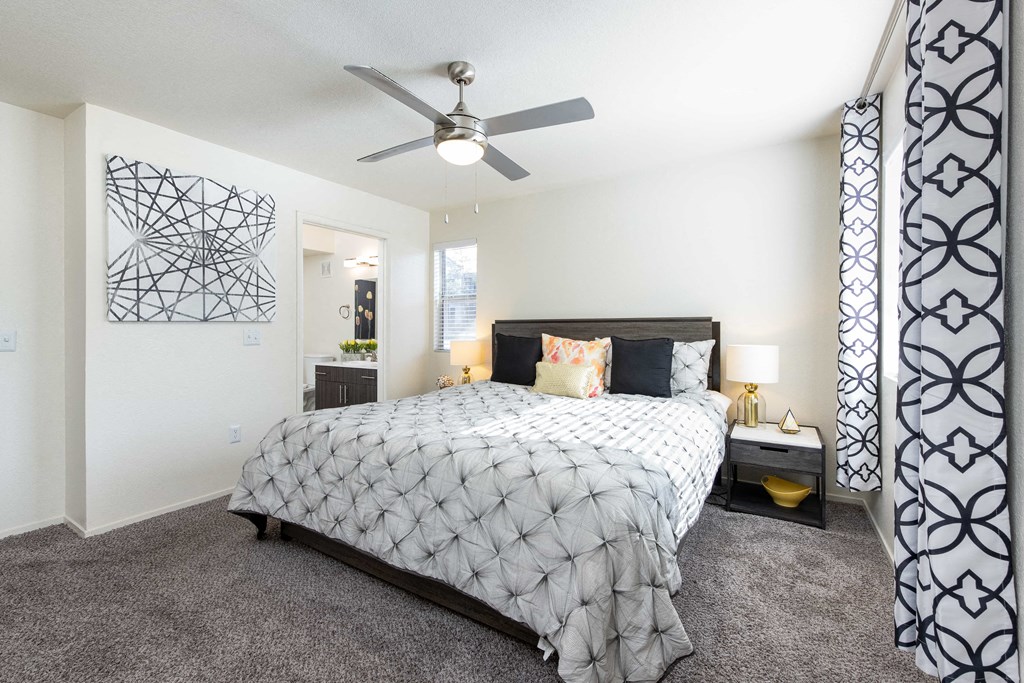 a bedroom with a bed and a ceiling fan