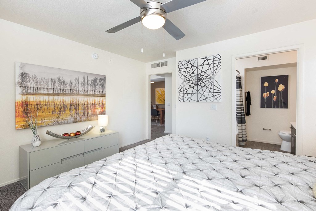 a bedroom with a bed and a ceiling fan