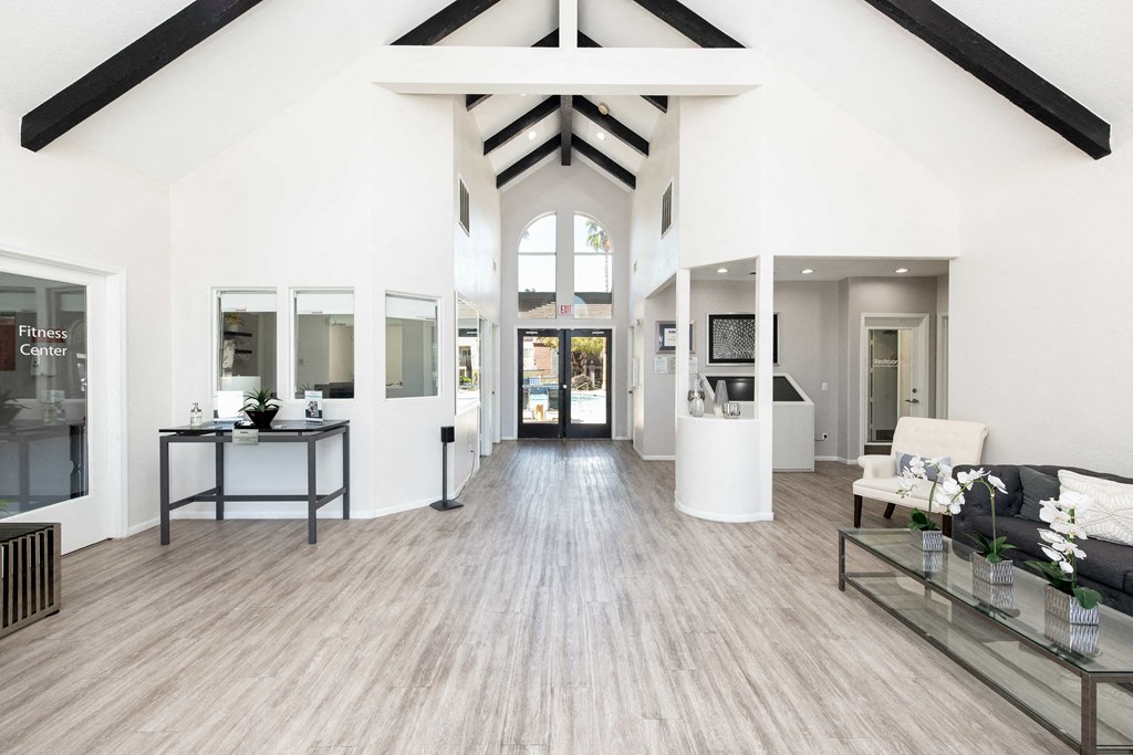 a living room with white walls and wood floors