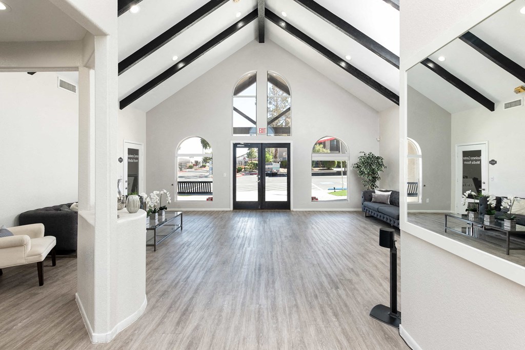 the living room of a new home with white walls and wood floors