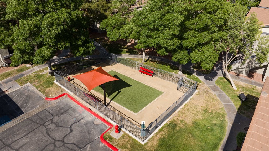 an aerial view of a park with a basketball court and a red court