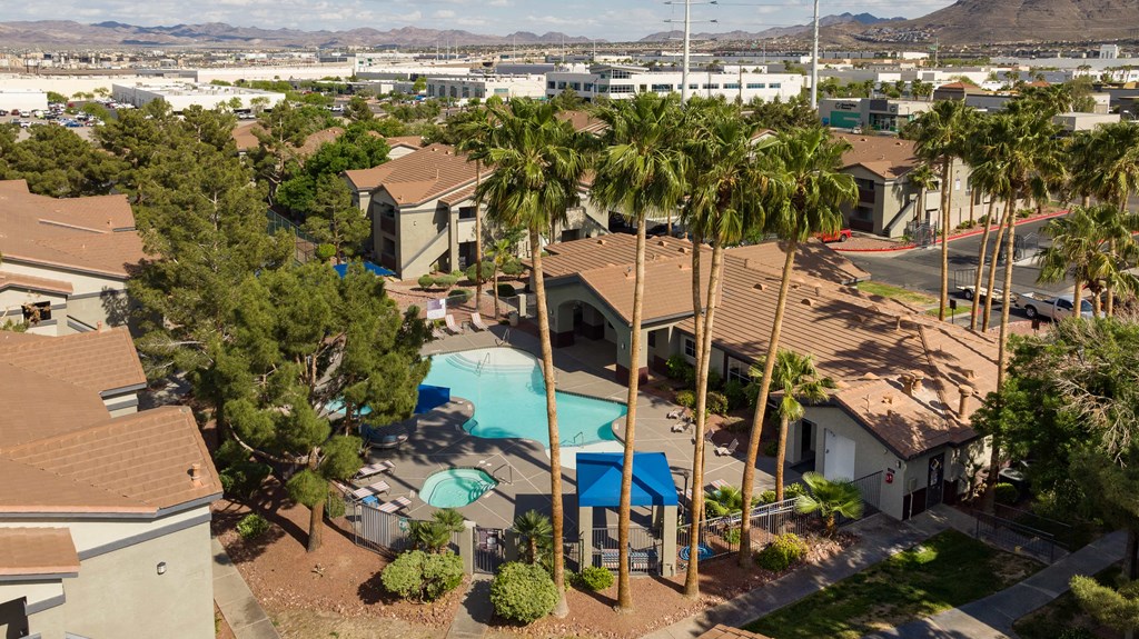 a house with a swimming pool and palm trees