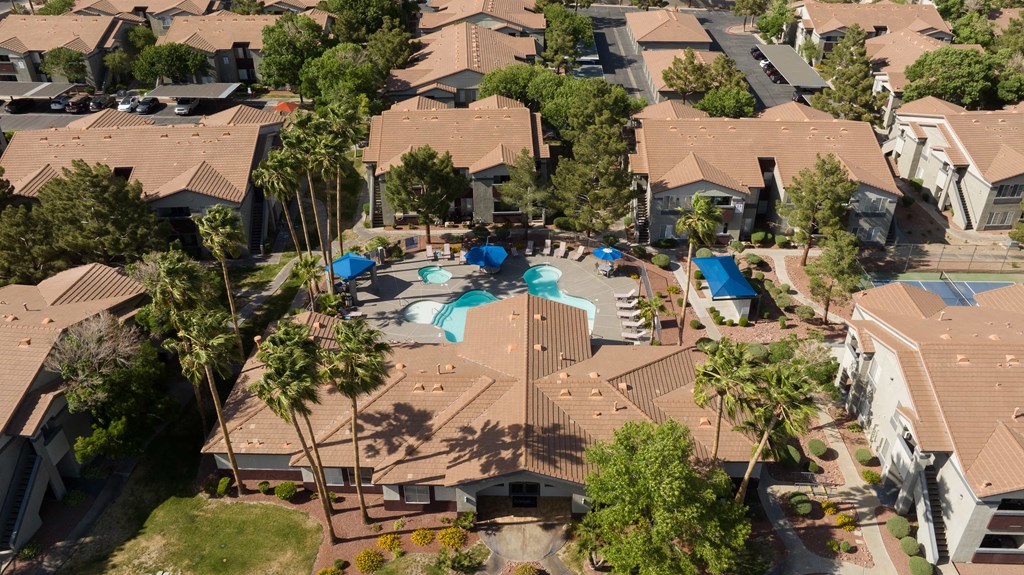 an aerial view of a neighborhood with houses and a swimming pool