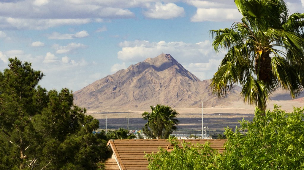 a view of a mountain and the ocean from a roof