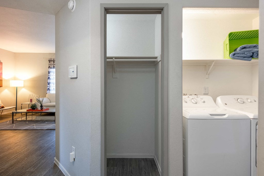 a laundry room with a washer and dryer and a closet with a sink