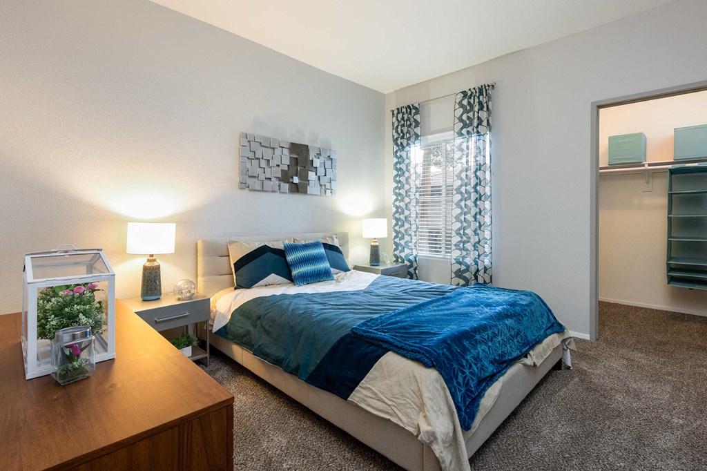 a bedroom with a bed and a dresser and a mirror