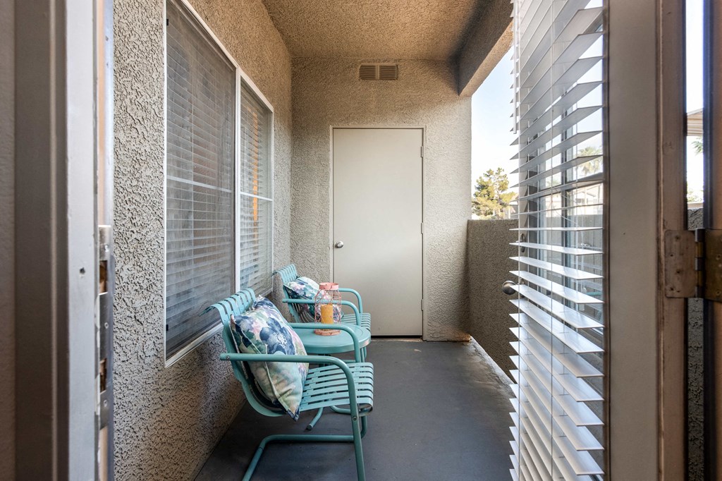 a front porch with a chair and a door
