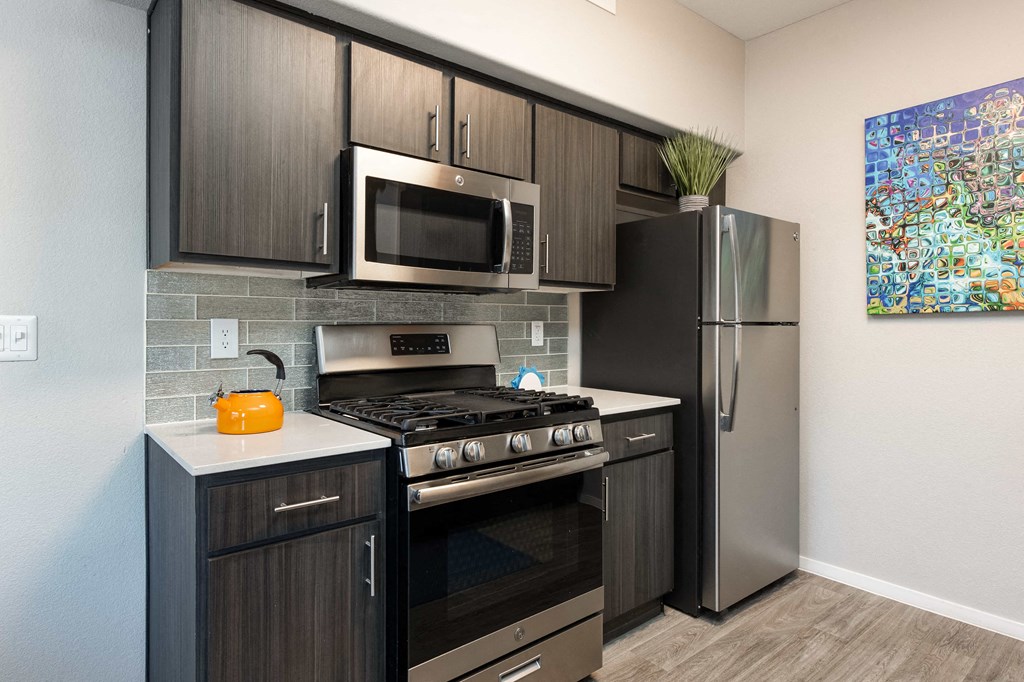a kitchen with stainless steel appliances and a refrigerator