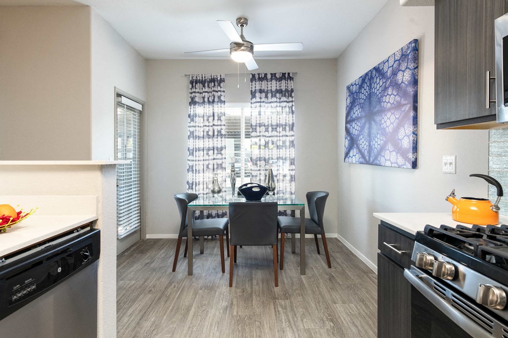 a kitchen and dining room area with a table and chairs and a stove