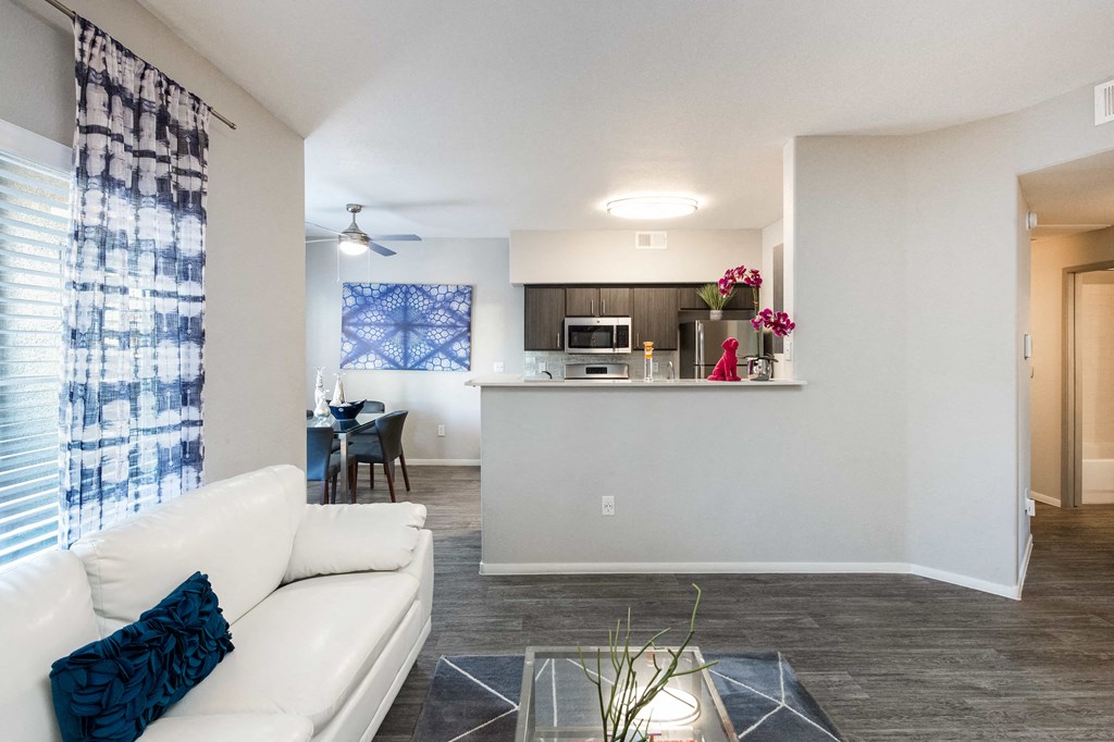 a living room and kitchen with a couch and a table