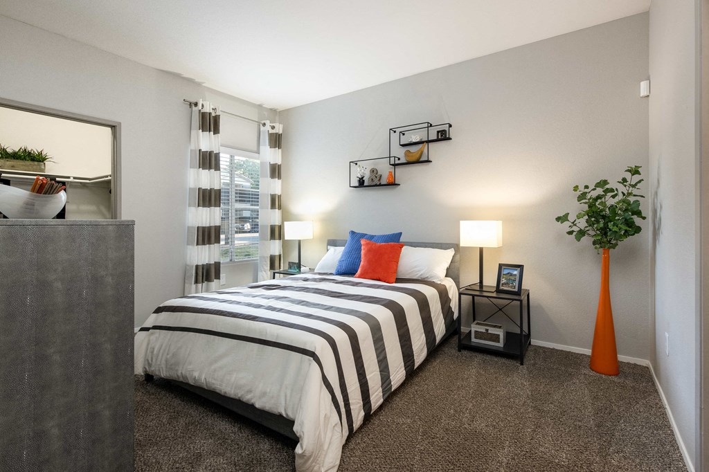 a bedroom with a bed and a dresser and a window