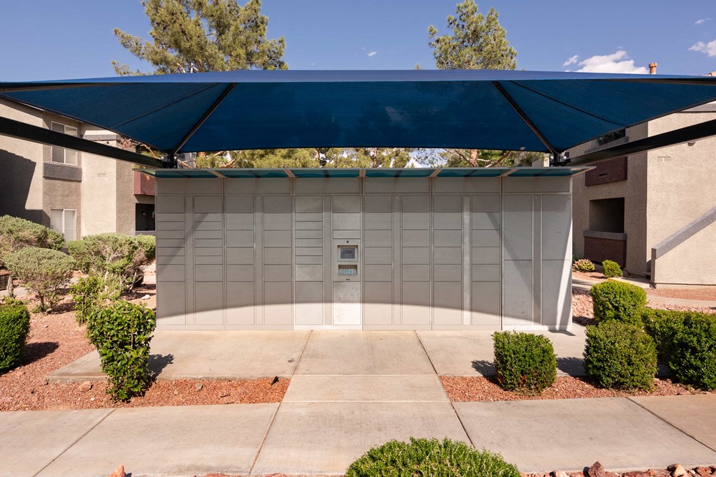 a garage with a blue awning in front of a building