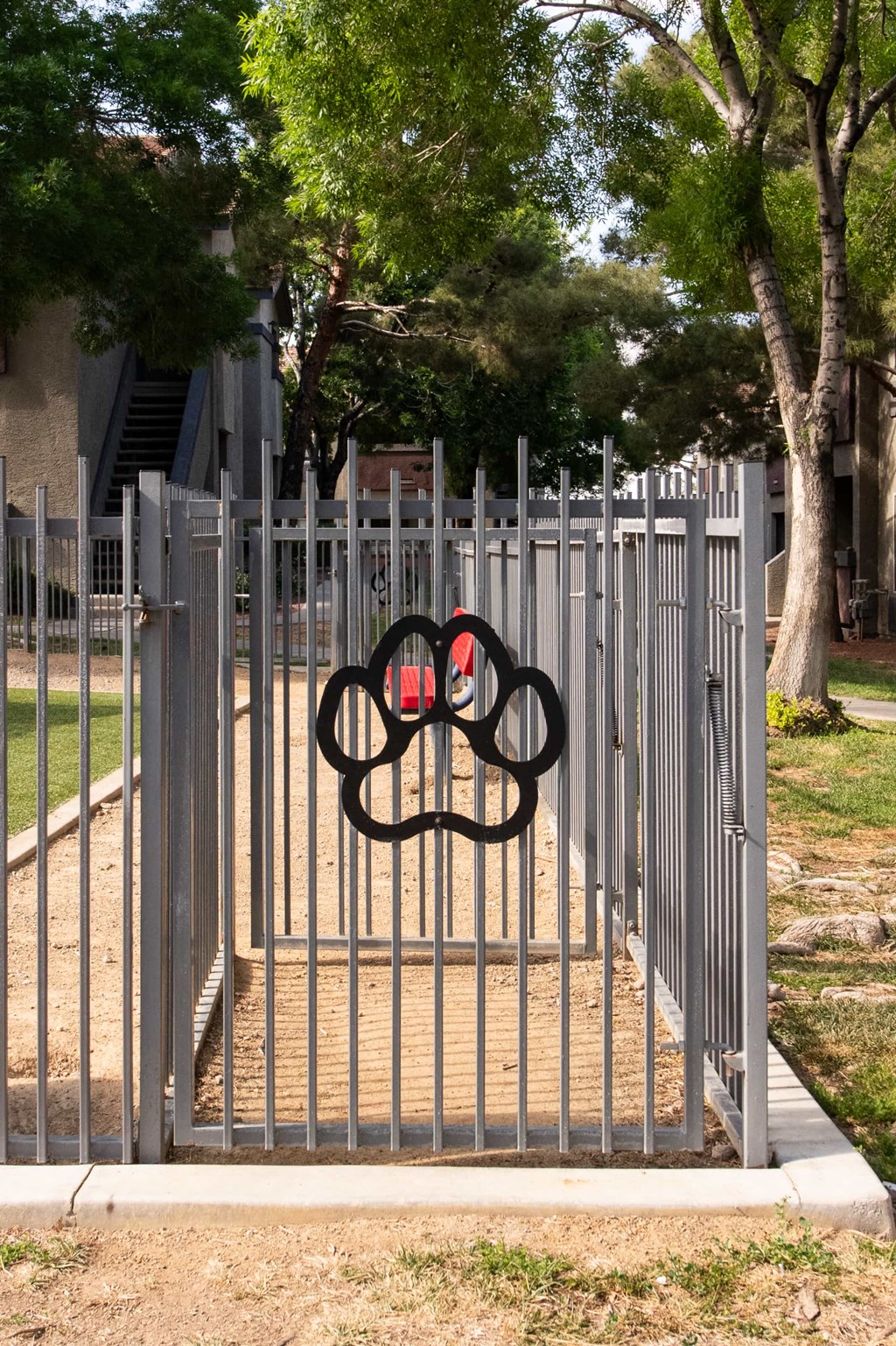 a gate with a olympic symbol on it in front of a fence