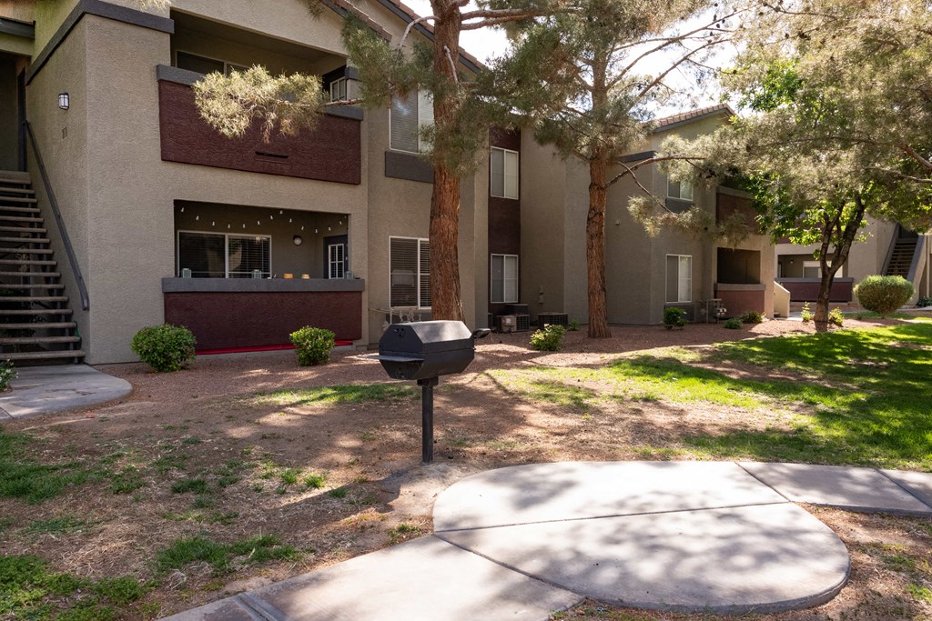 a yard in front of a house with a mailbox
