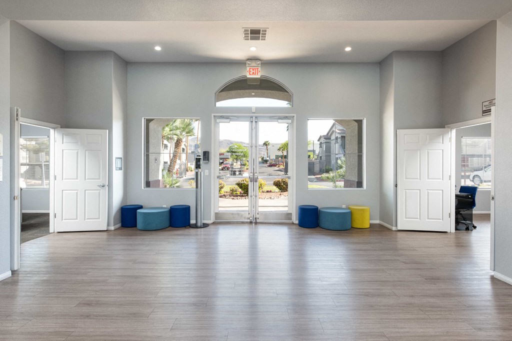 a large room with doors and windows and a hard wood floor