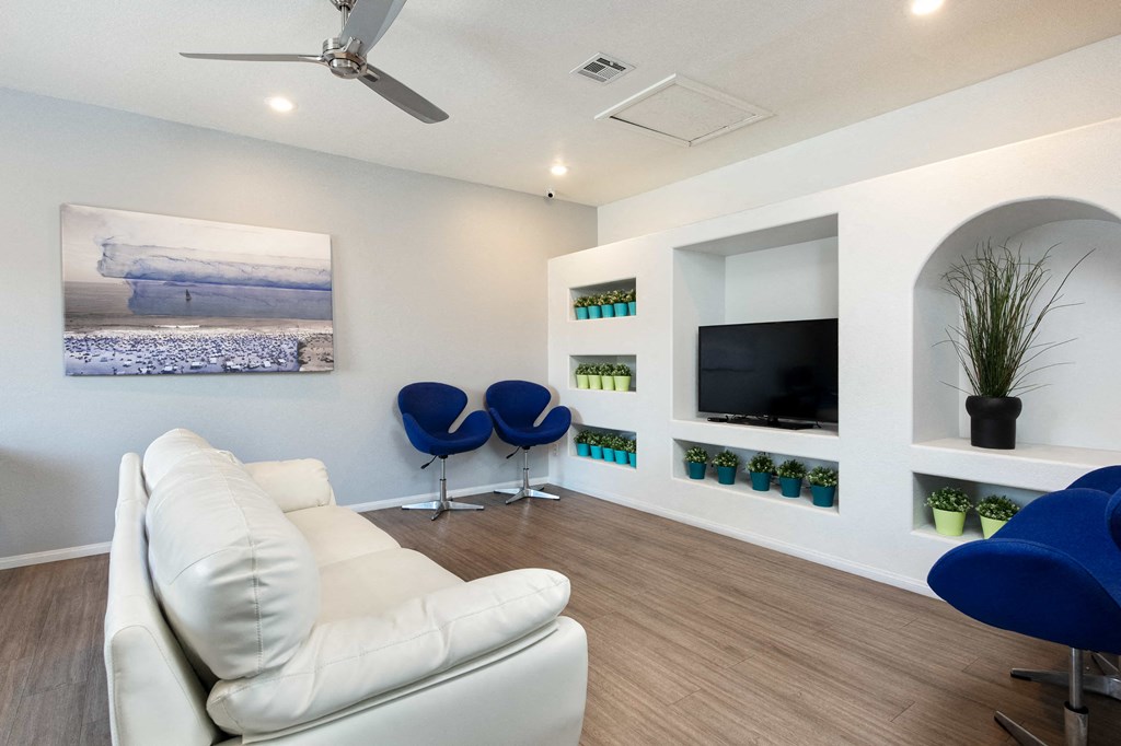 a living room with a white couch and a television