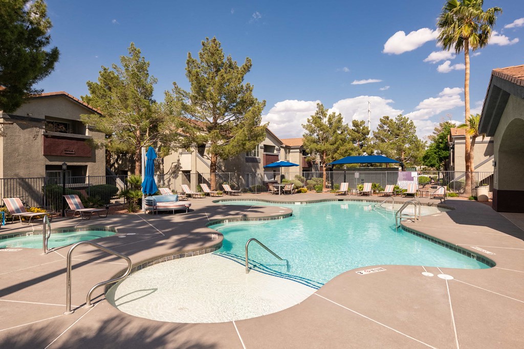 our apartments have a resort style pool with chairs and umbrellas