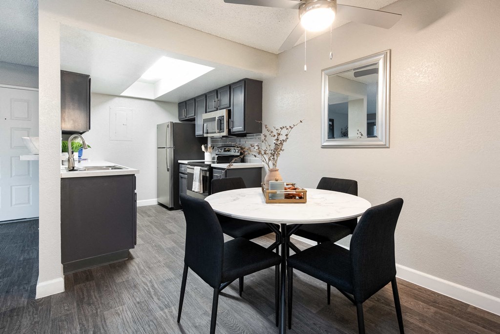 an open kitchen and dining area with a table and chairs
