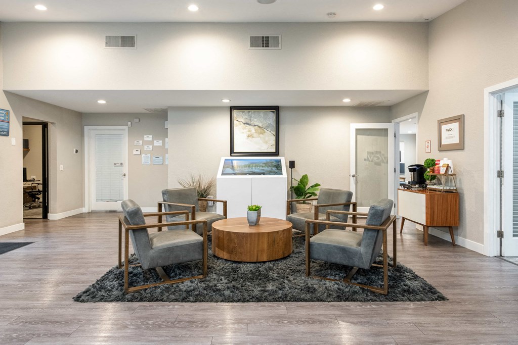 a living room with a table and chairs