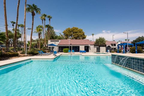a large swimming pool with a building in the background
