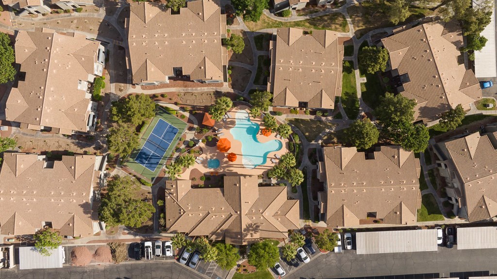 an aerial view of a neighborhood with houses and a swimming pool