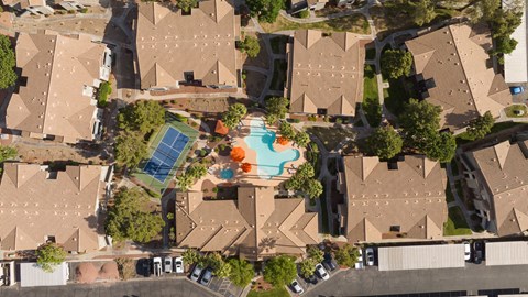 an aerial view of a neighborhood with houses and a swimming pool