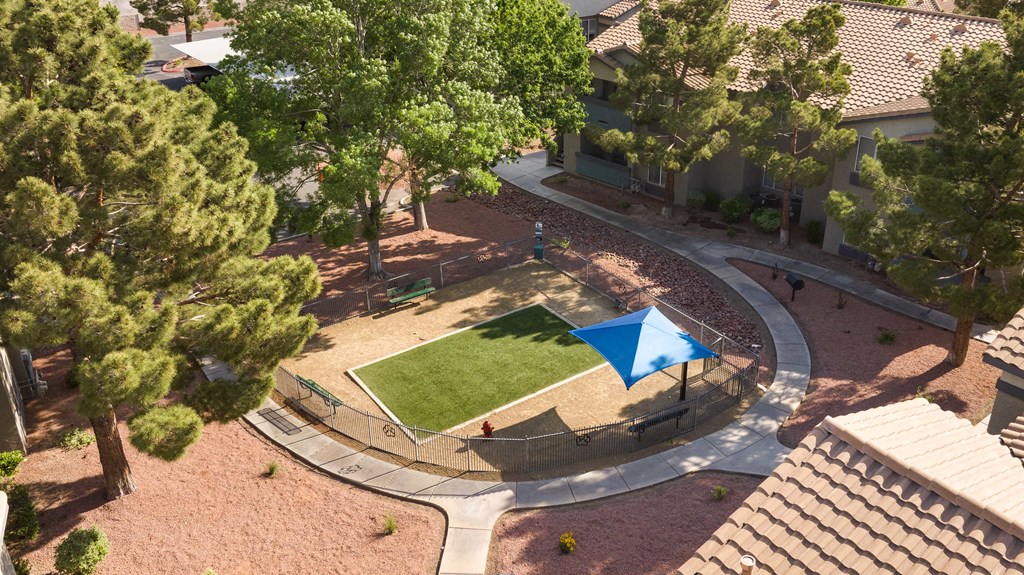 an aerial view of a tennis court in a park