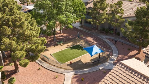 an aerial view of a tennis court in a park