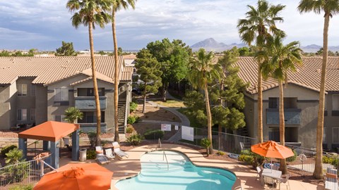 an aerial view of a pool at the resort with palm trees