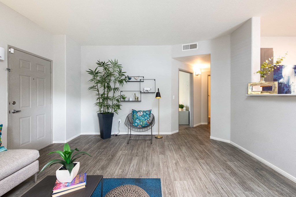 a living room with a couch and a chair and a plant