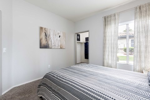 a bedroom with a bed and a window and a closet
