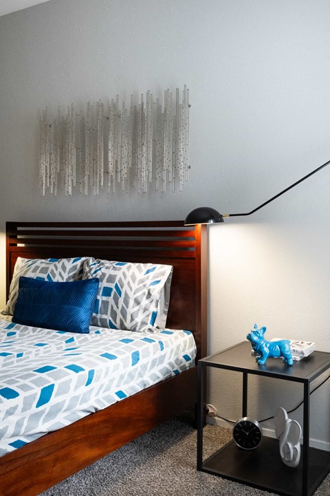 a small bedroom with a bed and a night stand