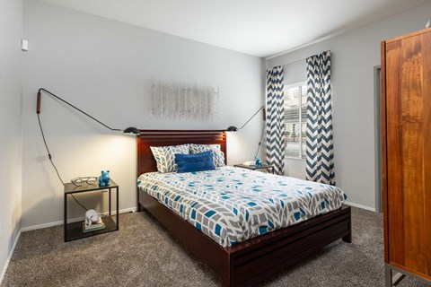 a bedroom with a bed and a window with curtains