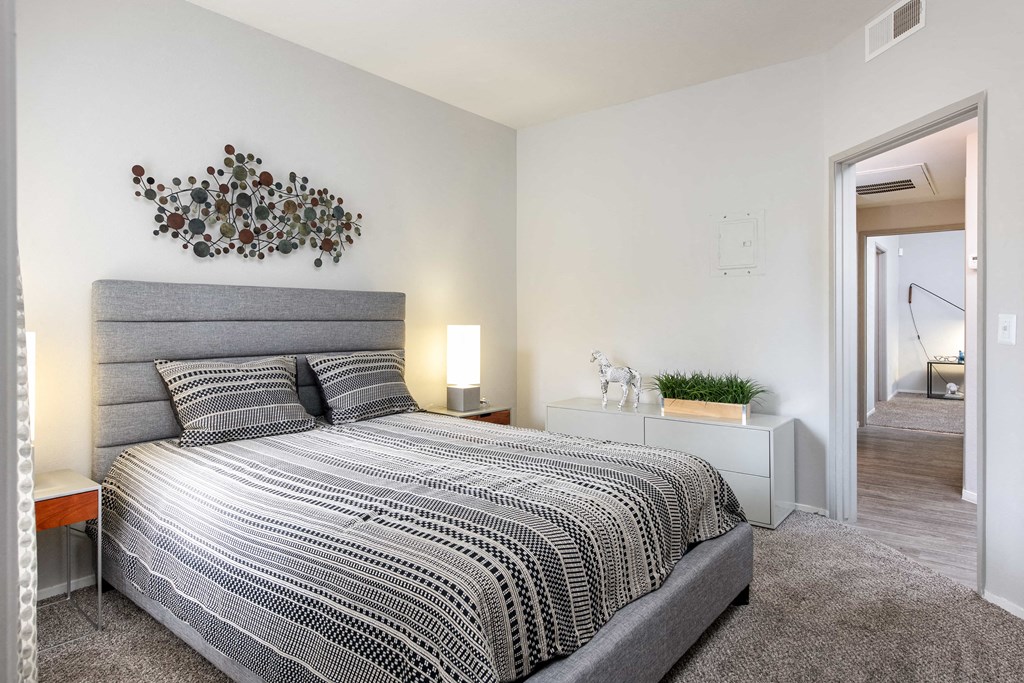 a bedroom with a large bed and a mirror