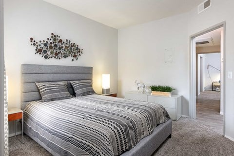 a bedroom with a large bed and a mirror