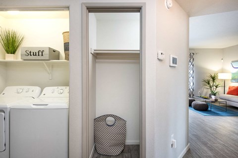 a laundry room with a washer and dryer and a closet