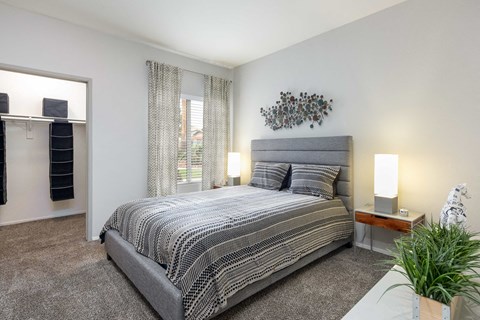 a bedroom with a bed and a window and a closet