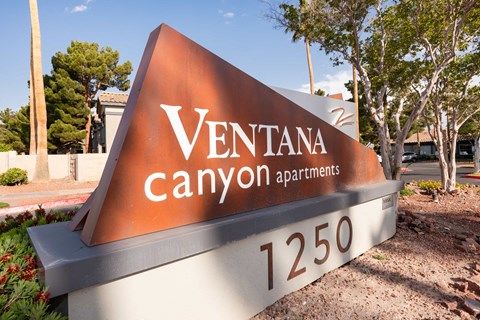 a sign that says ventana canyon apartments in front of a street