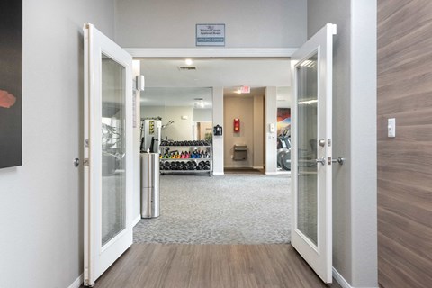 a view of a lobby with open doors and a wall with a bike rack