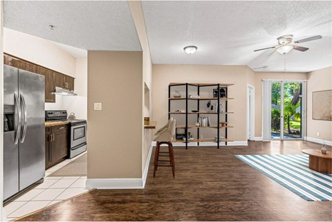 A kitchen with a refrigerator, oven, and microwave.