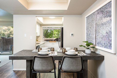 a kitchen and dining room with a table and chairs